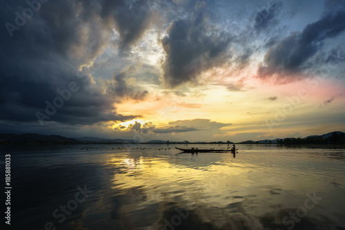 Lake with wooden boat at sunset in Vietnam