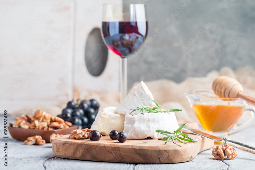 Brie cheese and slice on a wooden board Brie cheese and slice on a wooden board