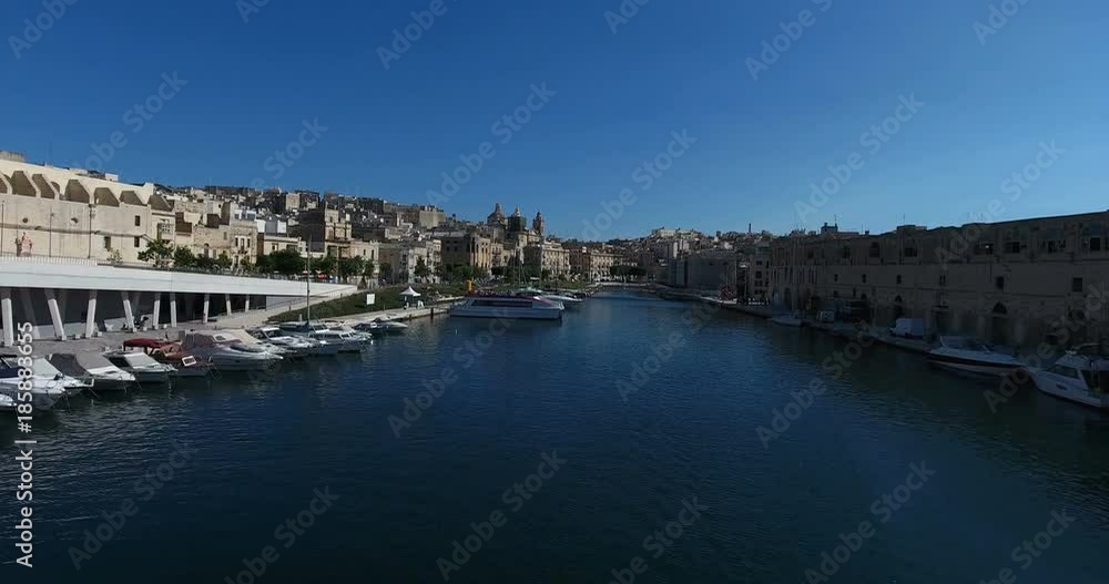 MALTA – AUGUST 2016 : Aerial shot over Valletta harbor on a sunny day with cityscape in view MALTA – AUGUST 2016 : Aerial shot over Valletta harbor on a sunny day with cityscape in view