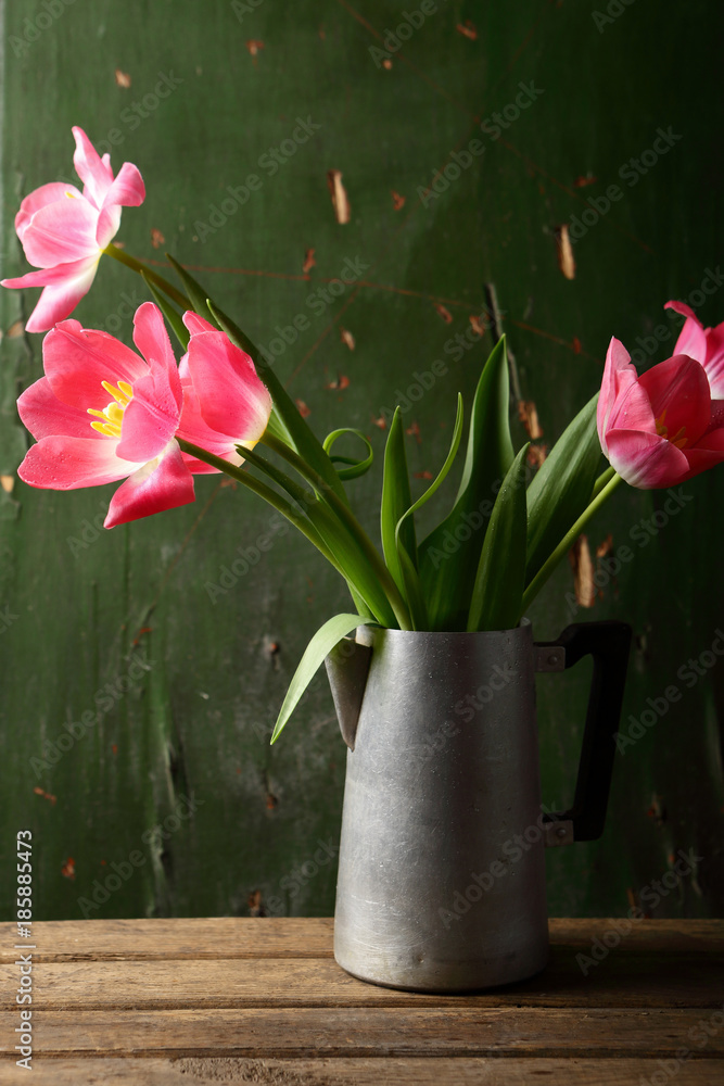 Pink tulips in rustic vase Pink tulips in rustic vase
