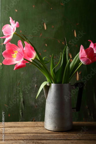 Pink tulips in rustic vase