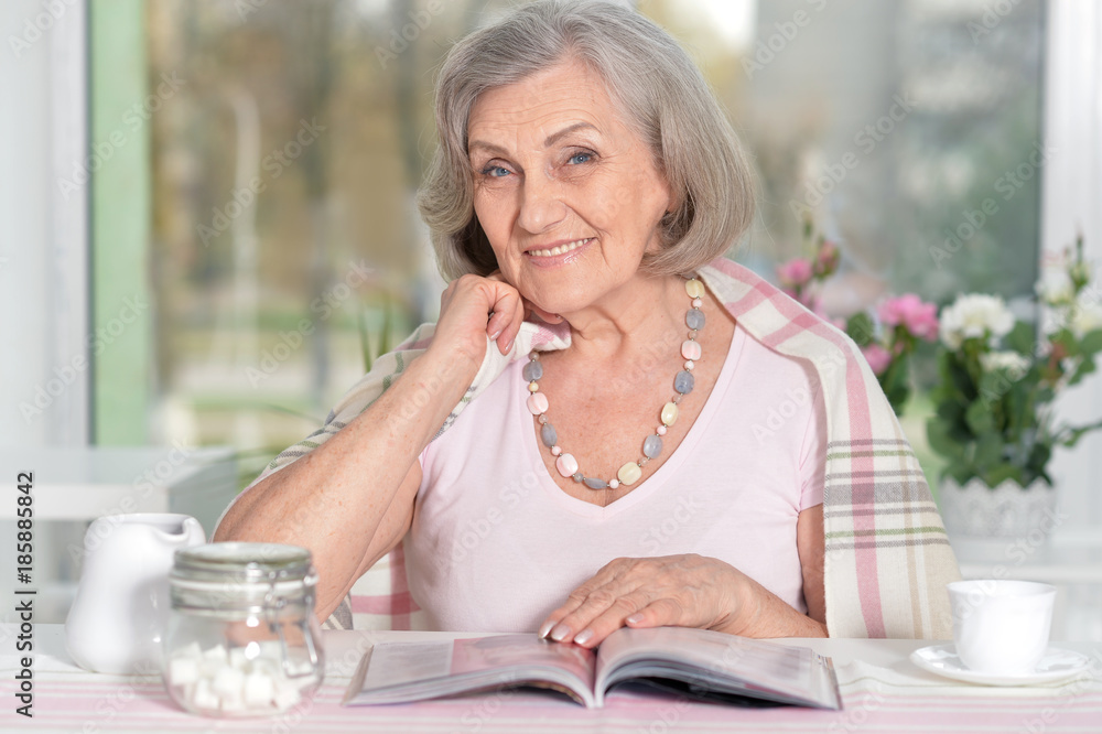 happy aged woman reading magazine happy aged woman reading magazine