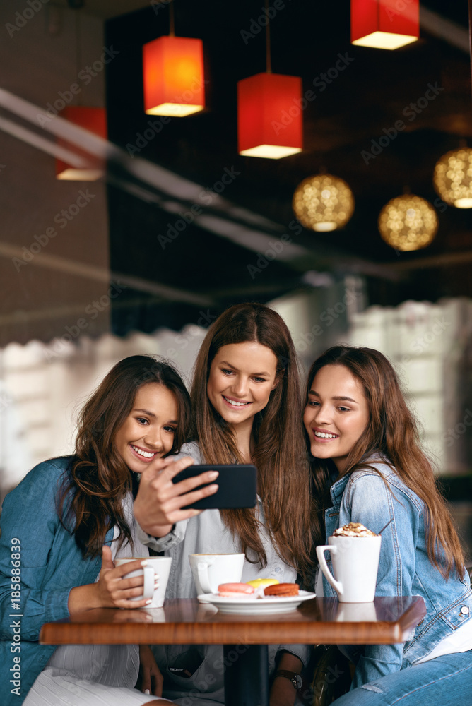 Beautiful Girls In Cafe Taking Selfie Photo On Phone.