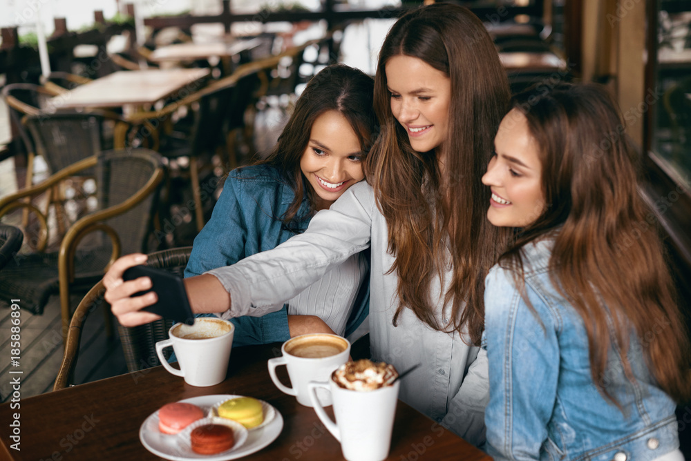 Beautiful Girls In Cafe Taking Selfie Photo On Phone.