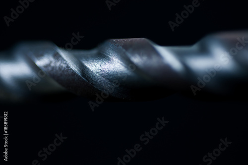 Concrete drill bit close up macro shot isolated on black background.