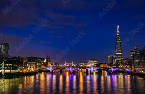 London cityscape with Southwark Bridge and Shard skyscraper at night