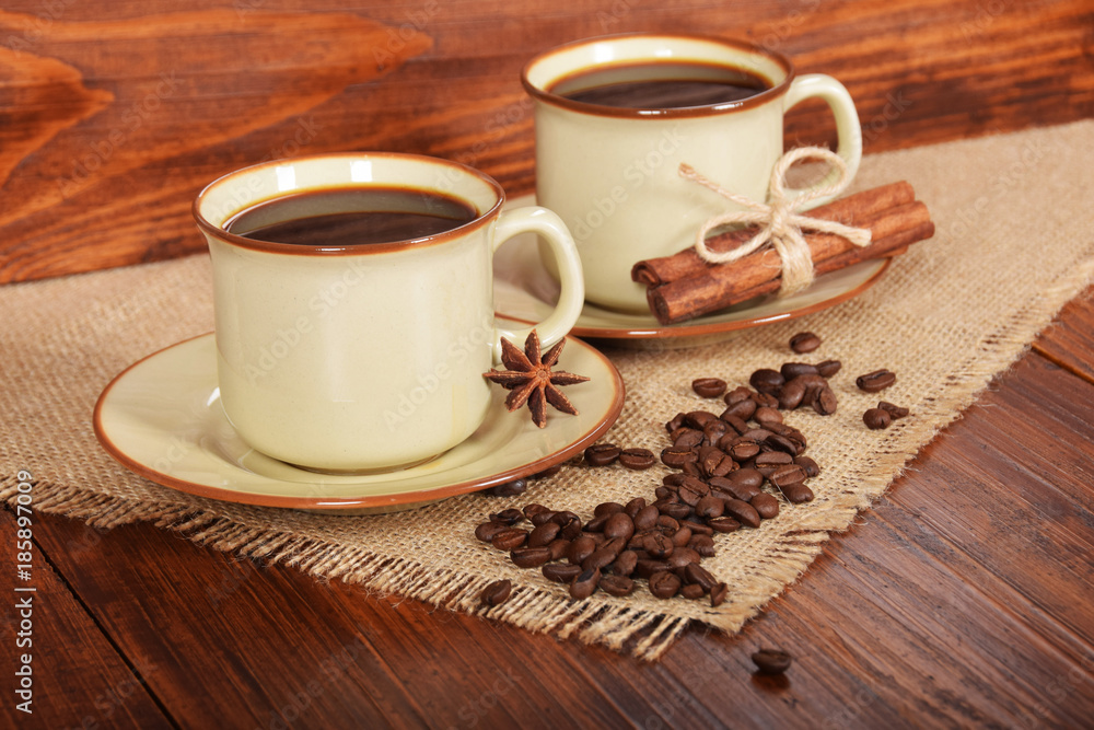 black sweet coffee in brown cups with vanilla cane and anise flower black sweet coffee in brown cups with vanilla cane and anise flower