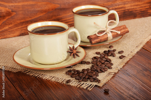 black sweet coffee in brown cups with vanilla cane and anise flower