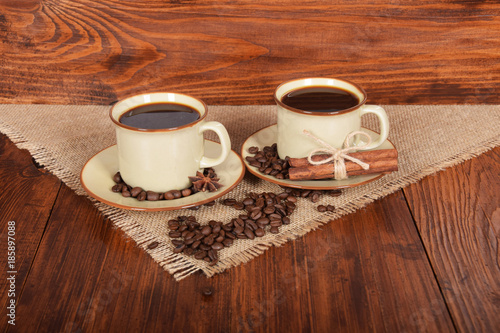 black sweet coffee in brown cups with vanilla cane and anise flower