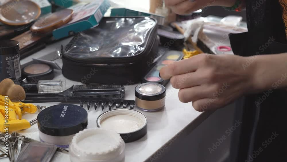 a table on which lies a large number of cosmetics. eye shadow, pout, lipstick. professional cosmetics for make-up. close-up shot. 4k a table on which lies a large number of cosmetics. eye shadow, pout, lipstick. professional cosmetics for make-up. close-up shot. 4k