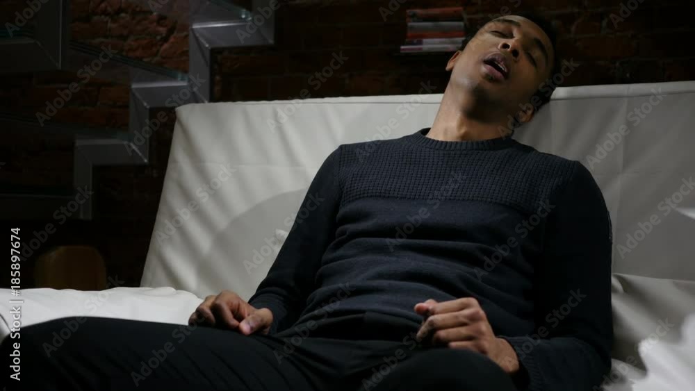 Sleeping Tired African Man Sitting in Loft Interior Sleeping Tired African Man Sitting in Loft Interior