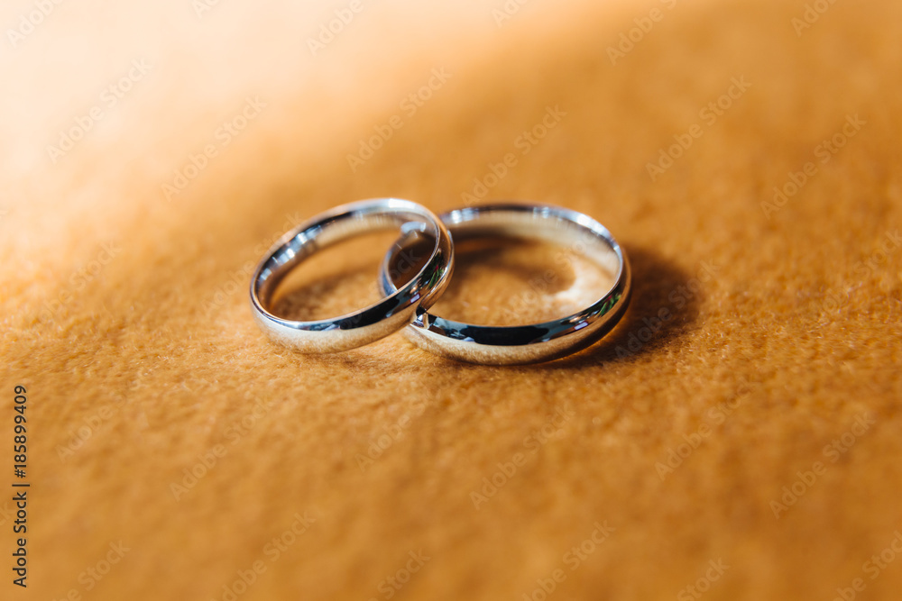Close-up two silver wedding rings on fabric background. Close-up two silver wedding rings on fabric background.
