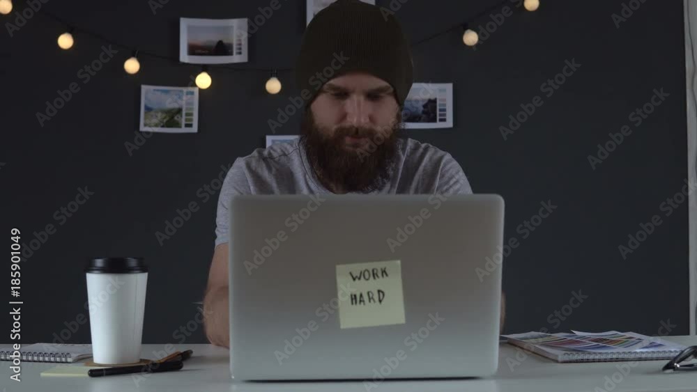 Web developer drinking coffee and working on the computer at home Web developer drinking coffee and working on the computer at home