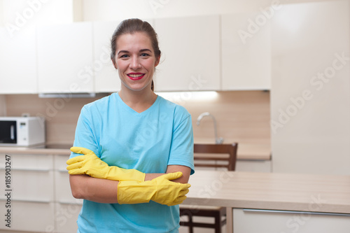 Housewife concept. Portrait of  beautiful young woman in rubber gloves during house cleaning