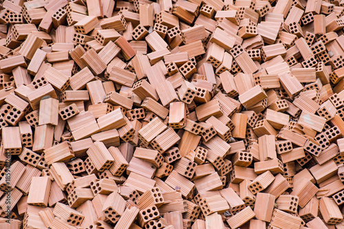 Background and texture of stack red bricks prepare to construction building