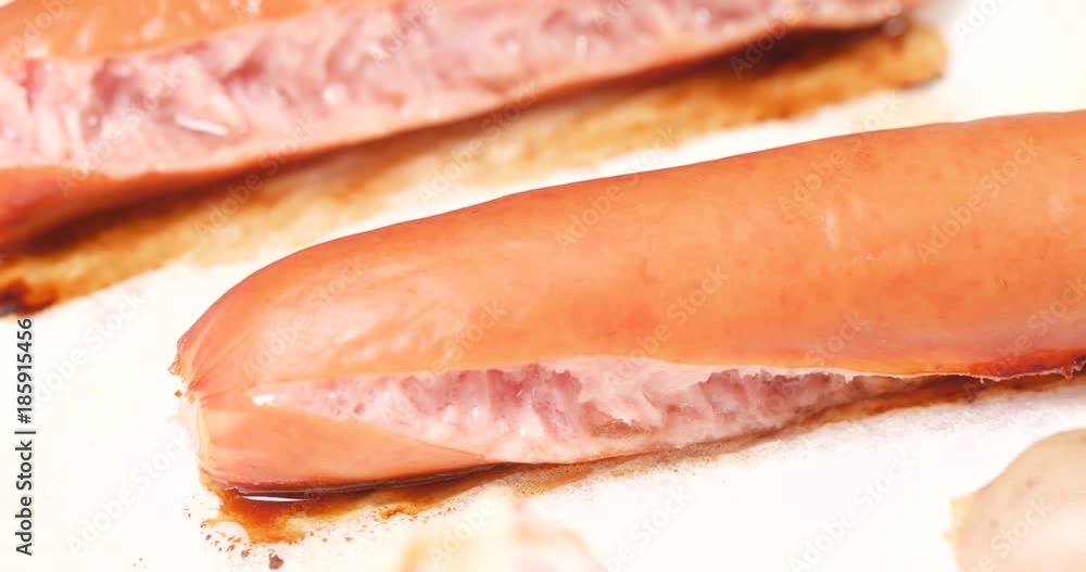 Baked sausage taking out from heat oven Baked sausage taking out from heat oven