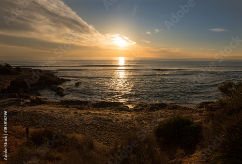 The calm sea in a very cloudy sunset