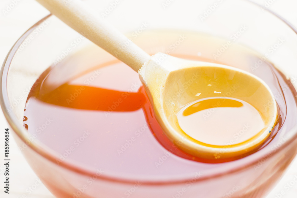 A bowl of honey with a spoon A bowl of honey with a spoon