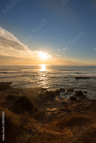 The calm sea in a very cloudy sunset