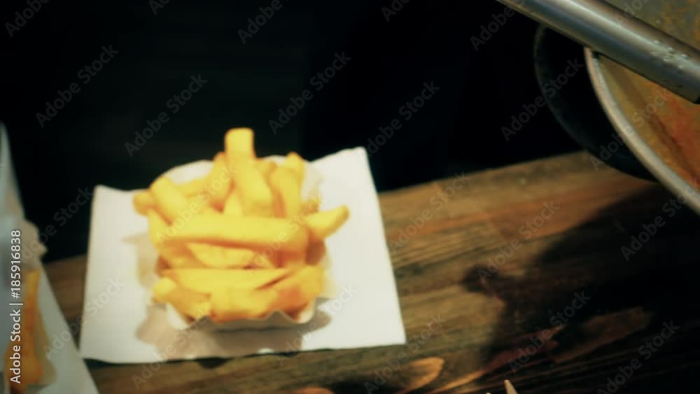 French fries served on white paper plate, close up French fries served on white paper plate, close up