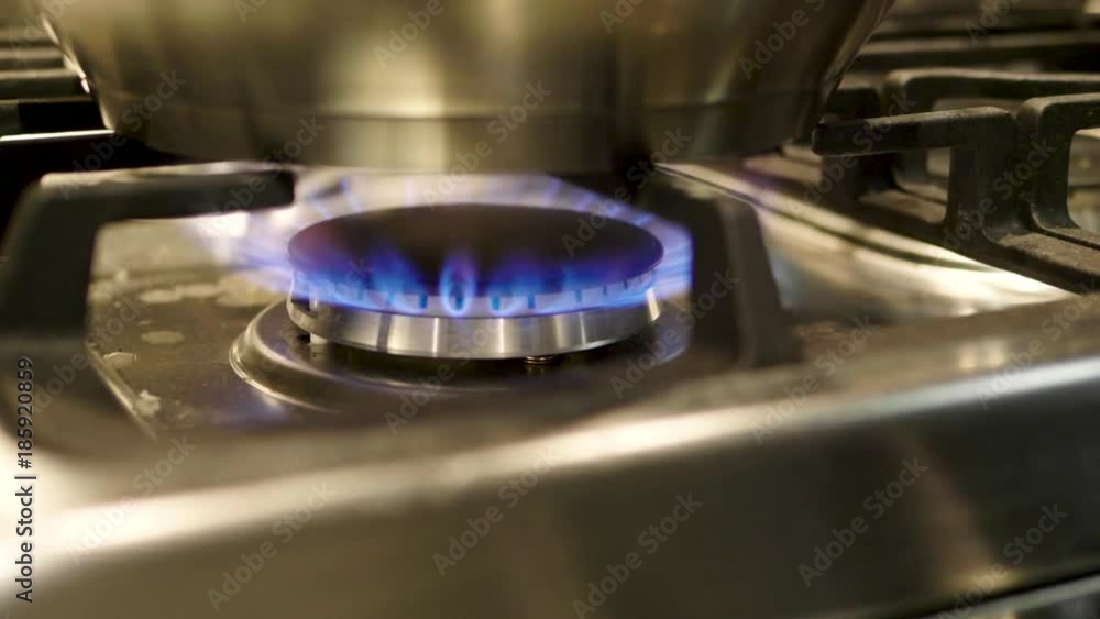 Close up of a gas lit burner on a stove top Close up of a gas lit burner on a stove top