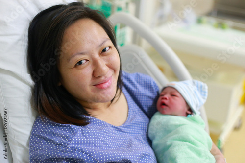 Mother holding her newborn child after labor