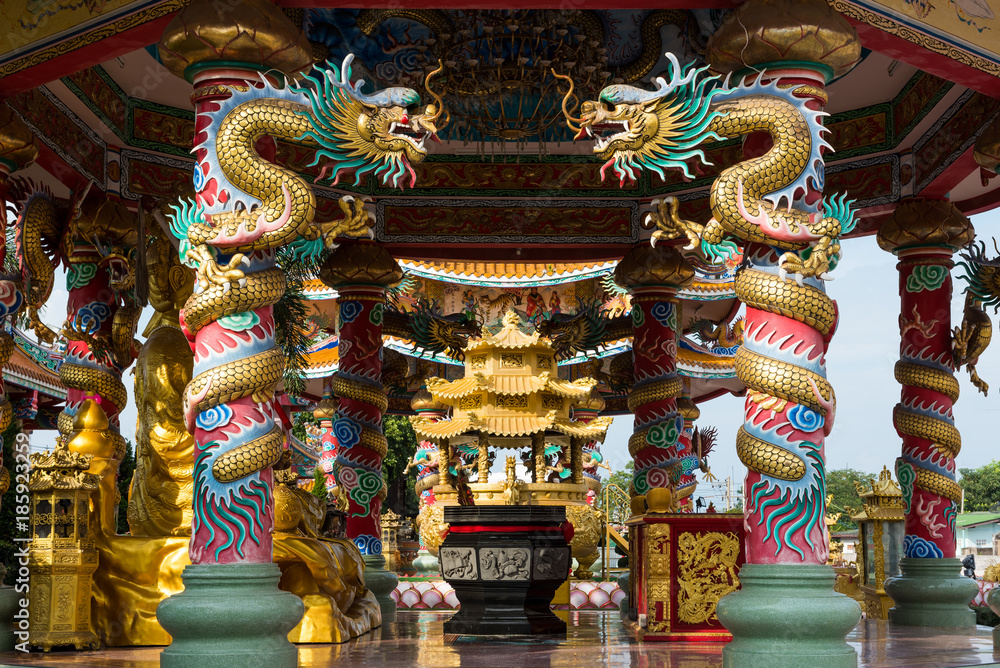 Two golden dragon on the poles in Chinese temple