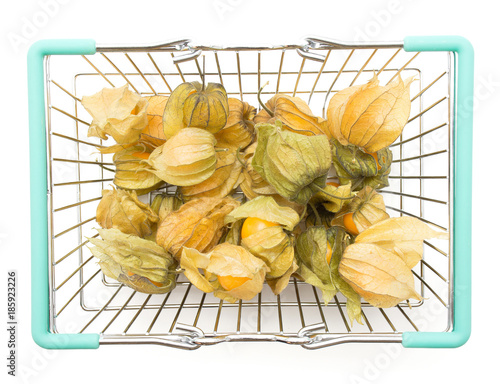 Physalis berries in a shopping basket isolated on white background top view. photo