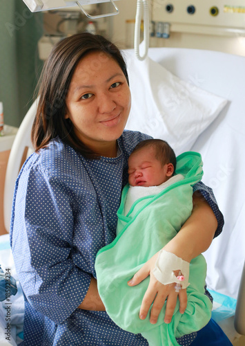 Mother holding her newborn child after labor