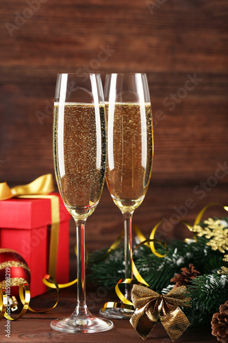 Champagne glasses with ribbon and fir-tree branches