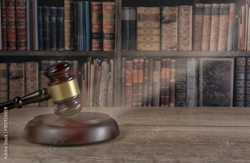  law theme, mallet of the judge, wooden desk, old books photo