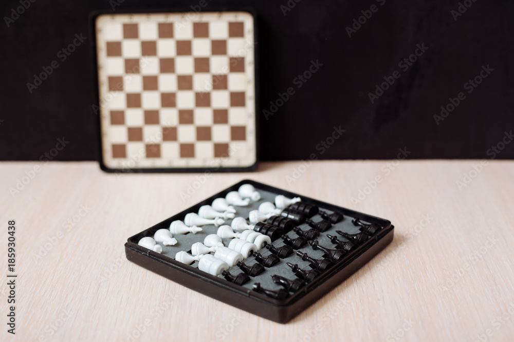 Chess and checkers on a wooden table and black background. Chess and checkers on a wooden table and black background.