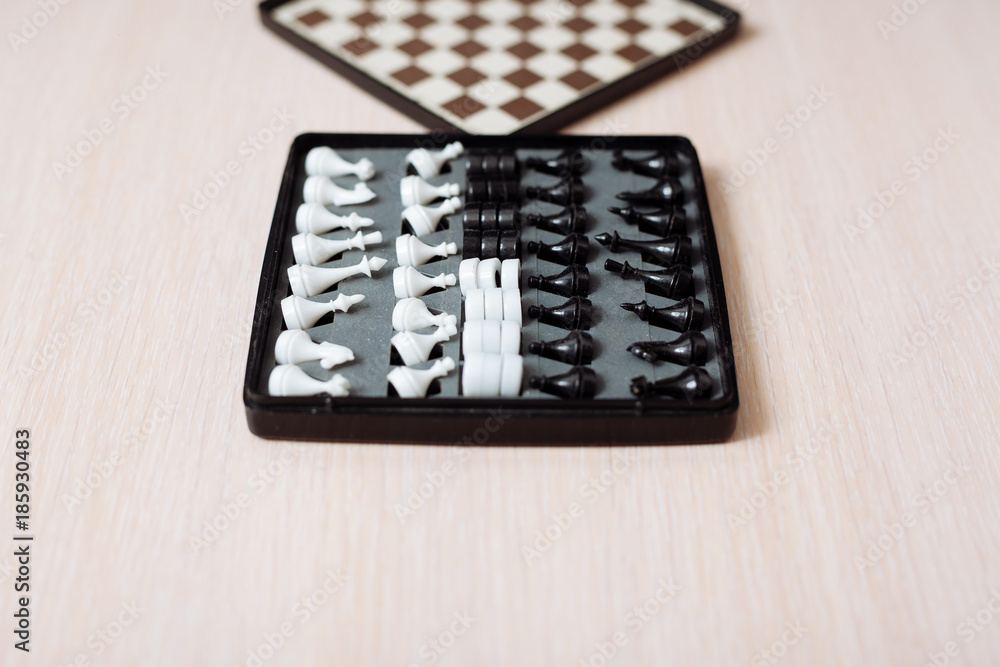 Chess and checkers on a wooden table and black background. Chess and checkers on a wooden table and black background.