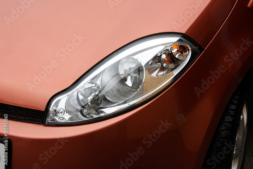 Car headlight car. The car is an orange color. Lighting devices of transport.
