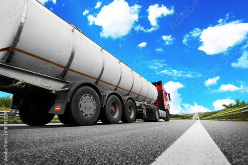 Big metal fuel tanker truck shipping fuel against sky