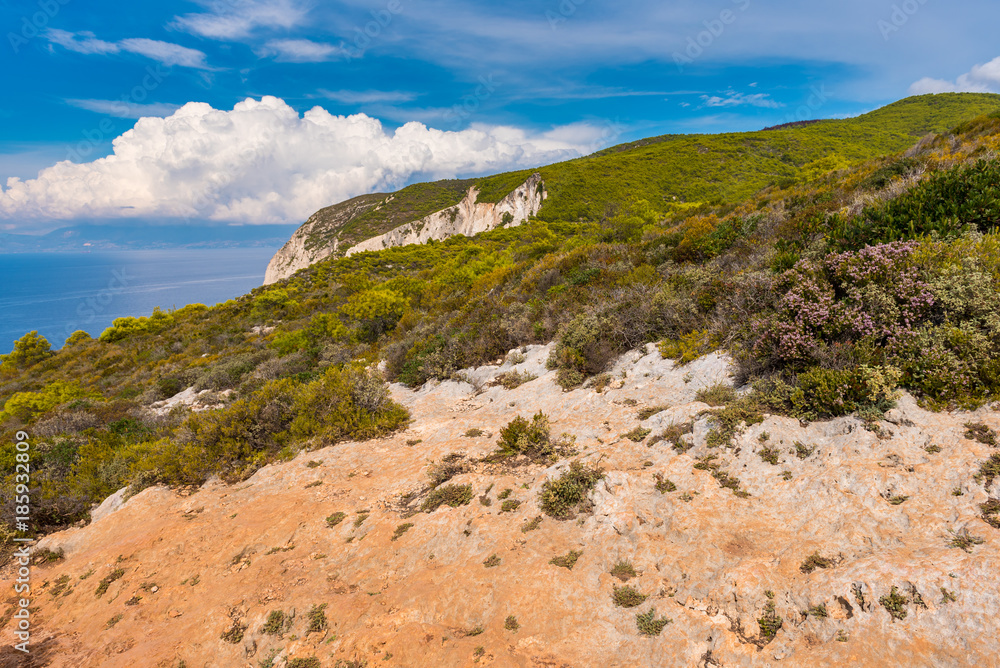Rocks and dry grass on seaside cliff. Beautiful view of sea waters and coast on Zakynthos island Greece. Rocks and dry grass on seaside cliff. Beautiful view of sea waters and coast on Zakynthos island Greece.