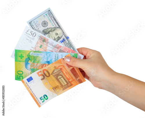 women's hand holding a money fan with four currencies