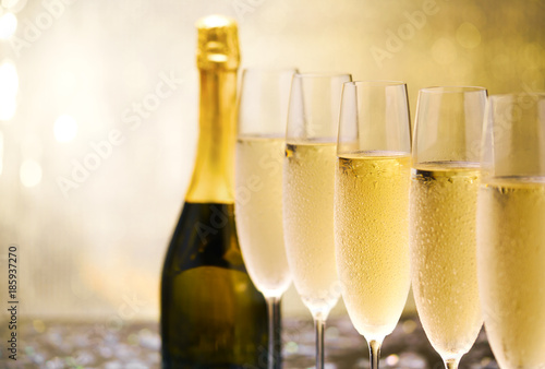 Many glasses of champagne in a line. Selective focus