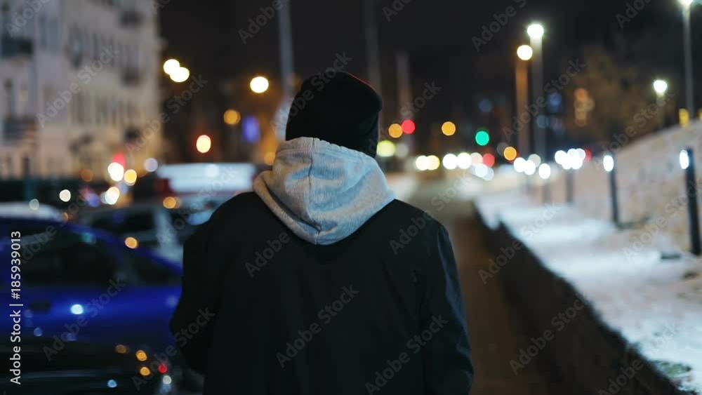 Back view young handsome man walking street night city blurred colored ...