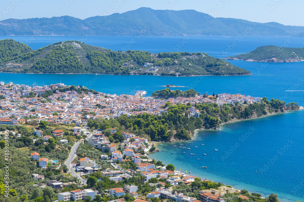Amazing view of Skiathos town in Greece with traditional houses and Skopelos in background
