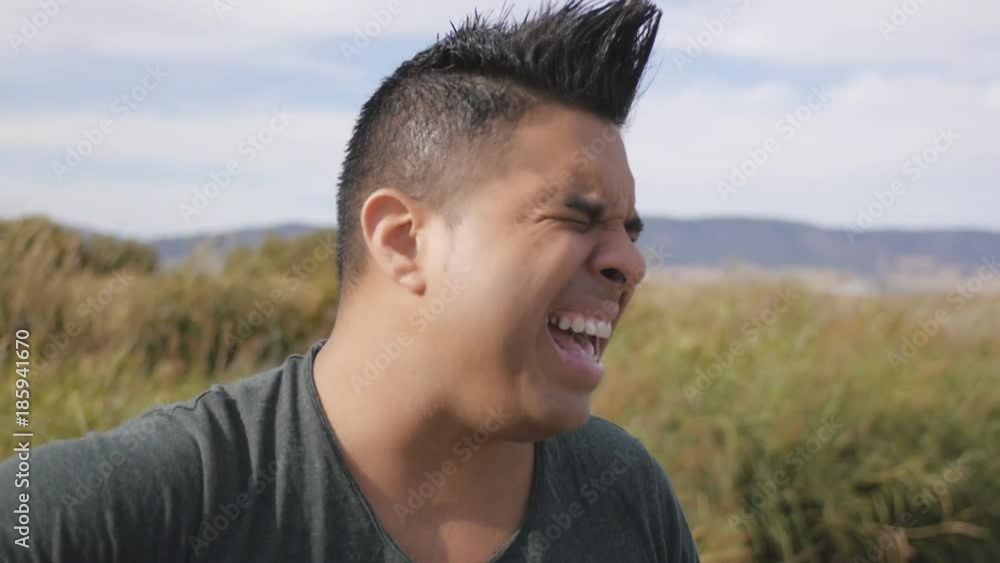 Woman and man sing a song with a guitar. Closeup of hispanic man singing and playing acoustic guitar on natural landscape background. Woman and man sing a song with a guitar. Closeup of hispanic man singing and playing acoustic guitar on natural landscape background.