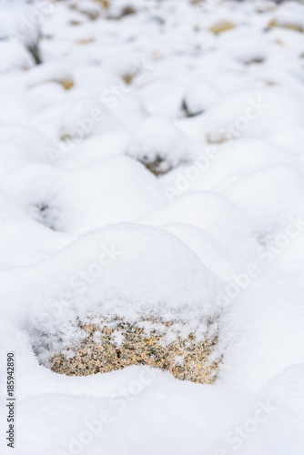 Fresh snowfall on a field of rocks, as a background 