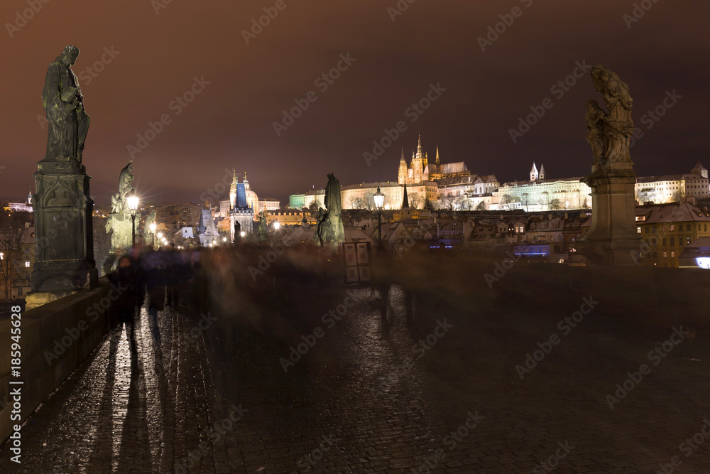 Night colorful snowy Christmas Prague Lesser Town with gothic Castle from Charles Bridge, Czech republic