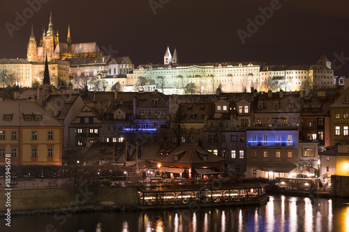 Night colorful snowy Christmas Prague Lesser Town with gothic Castle from Charles Bridge, Czech republic © Kajano