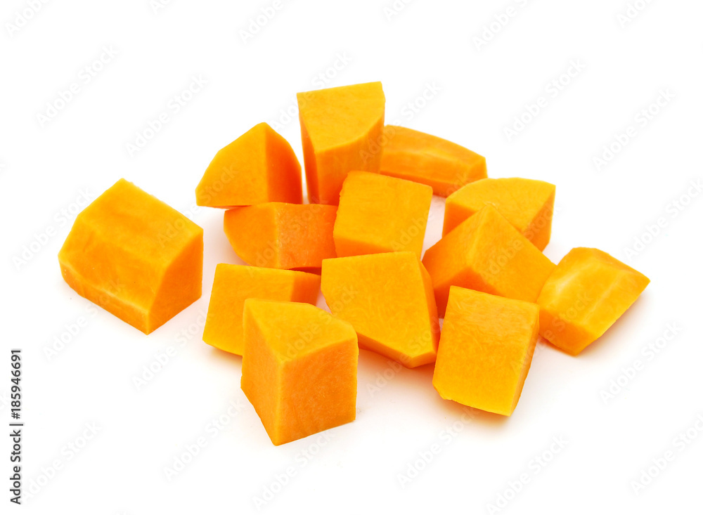 A group of cut and slice butternut squash chunks on a white background. A group of cut and slice butternut squash chunks on a white background.
