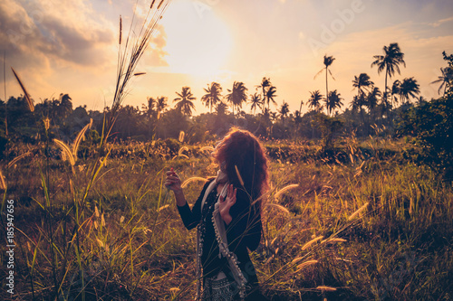 Fototapeta Naklejka Na Ścianę i Meble -  sunset portrait of beautiful young woman on a field