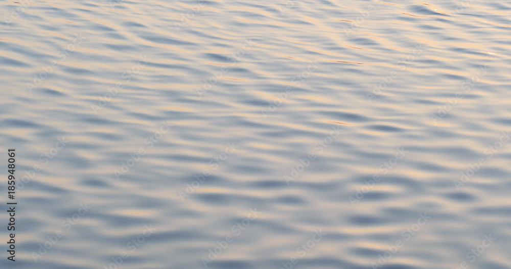 Water surface with a beautiful bokeh of sun glares Water surface with a beautiful bokeh of sun glares