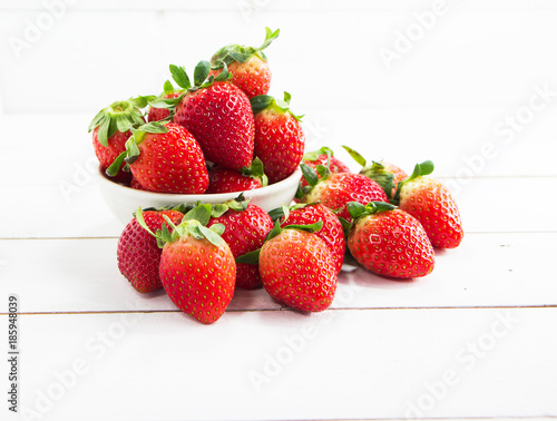 The red strawberry put on timber board blurry light around.Fresh fruit high vitamin and good for health.