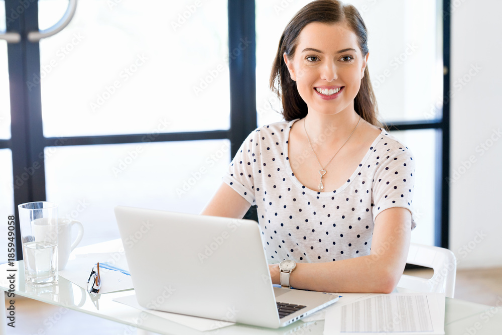 Portrait of businesswoman working at computer in office Portrait of businesswoman working at computer in office