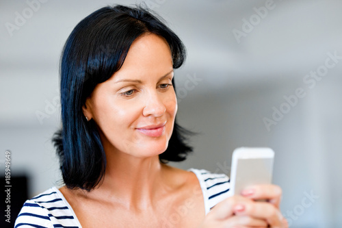 Portrait of attractive woman holding phone